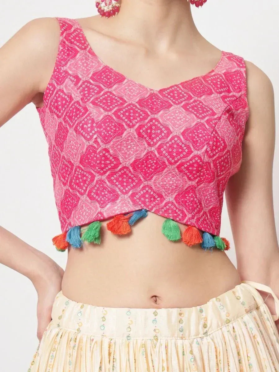 Pink embroidered crop top with colorful tassels, paired with ethnic skirt for festive wear