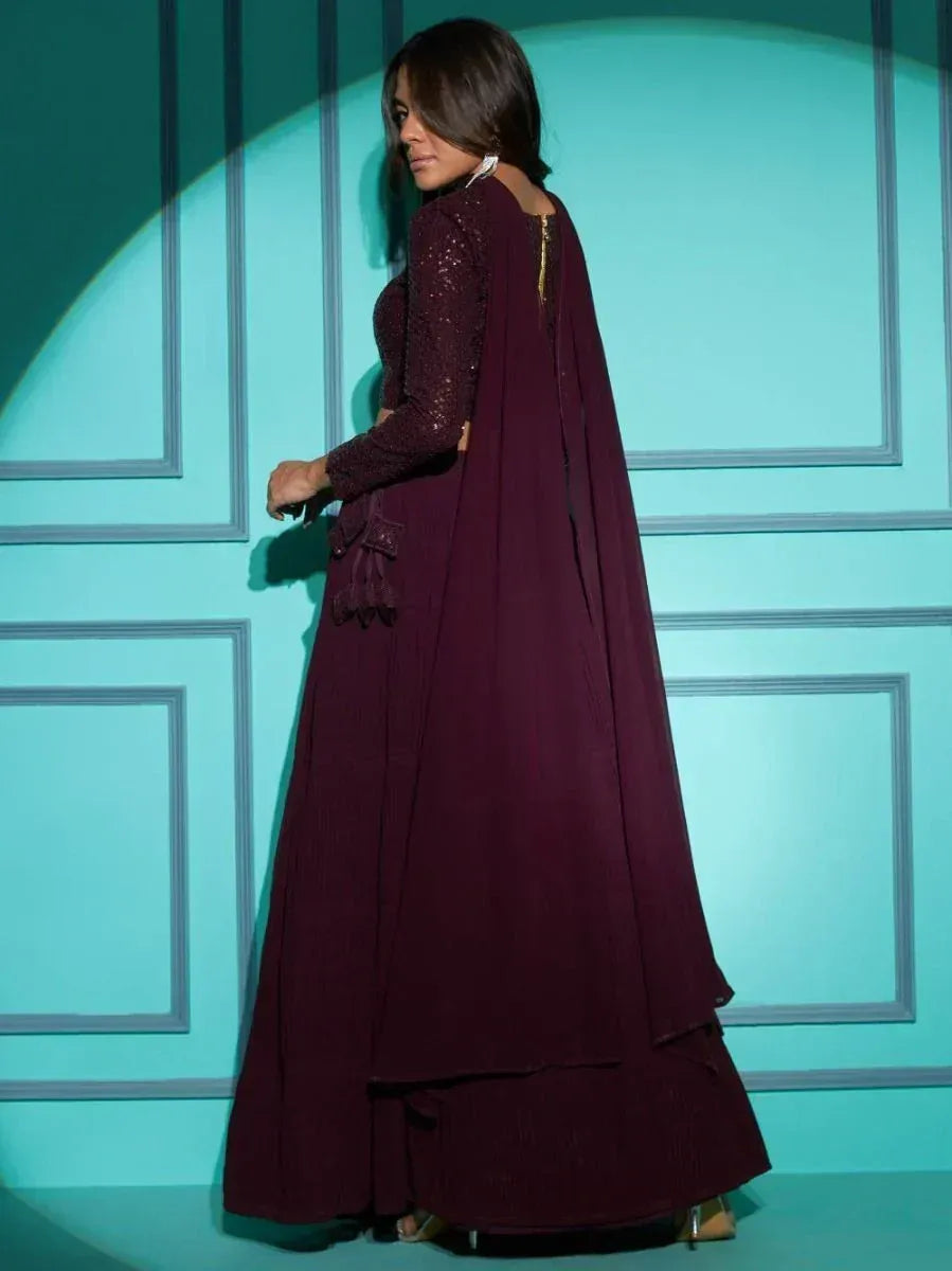 Elegant maroon ethnic gown with lace sleeves and cape back, perfect for Indian occasions