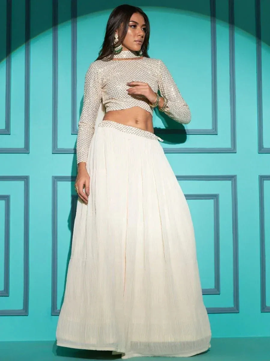 Elegant white embroidered lehenga choli with long sleeves, perfect for Indian ethnic wear occasions.
