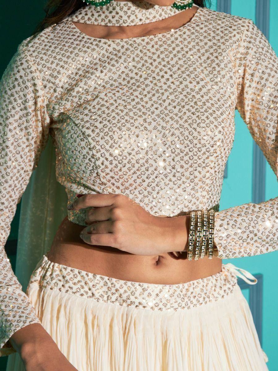 Elegant ivory sequin lehenga choli with floral pattern, perfect for Indian ethnic wear occasions