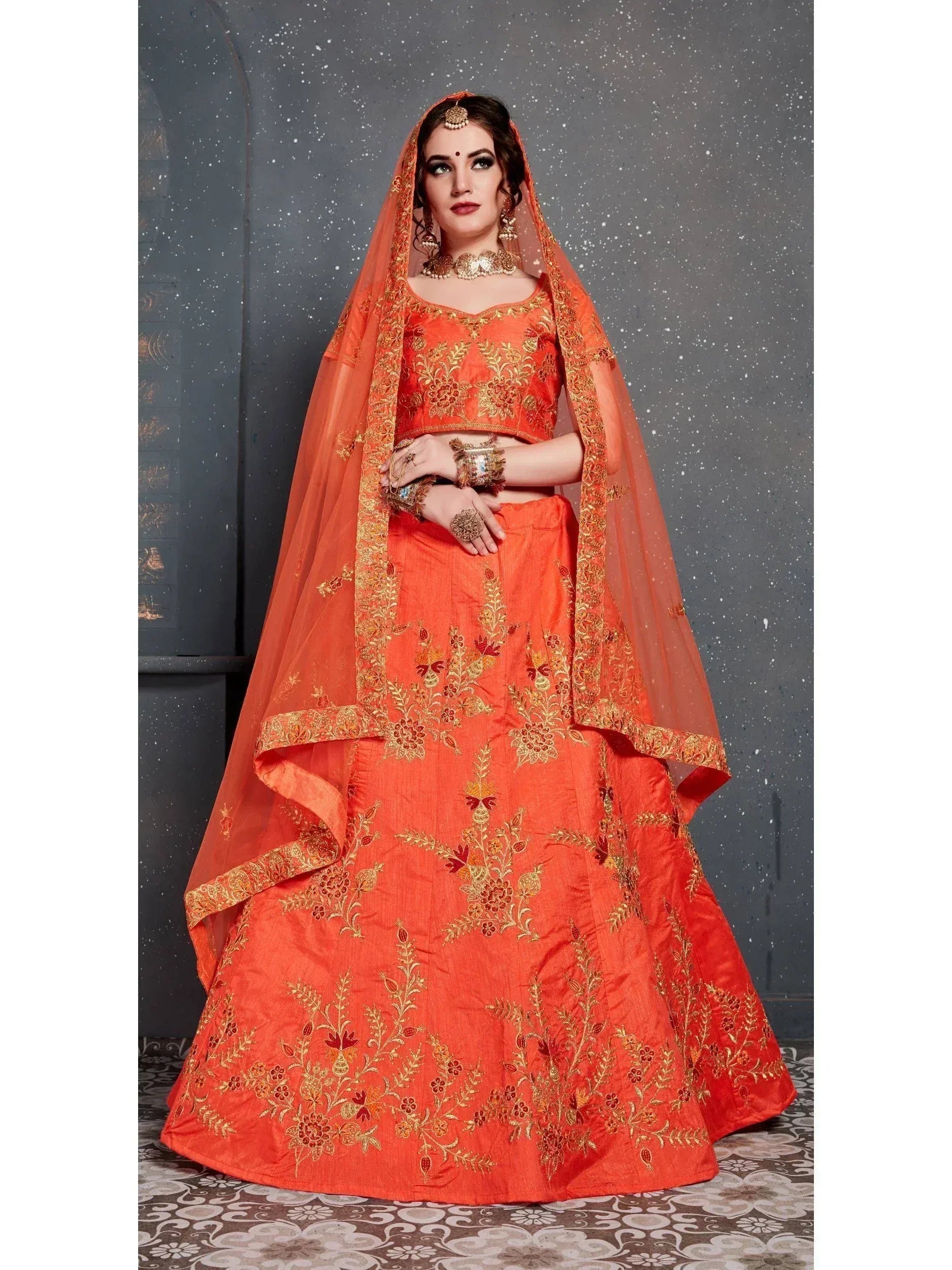 Orange embroidered lehenga choli with gold floral work and matching dupatta for Indian weddings