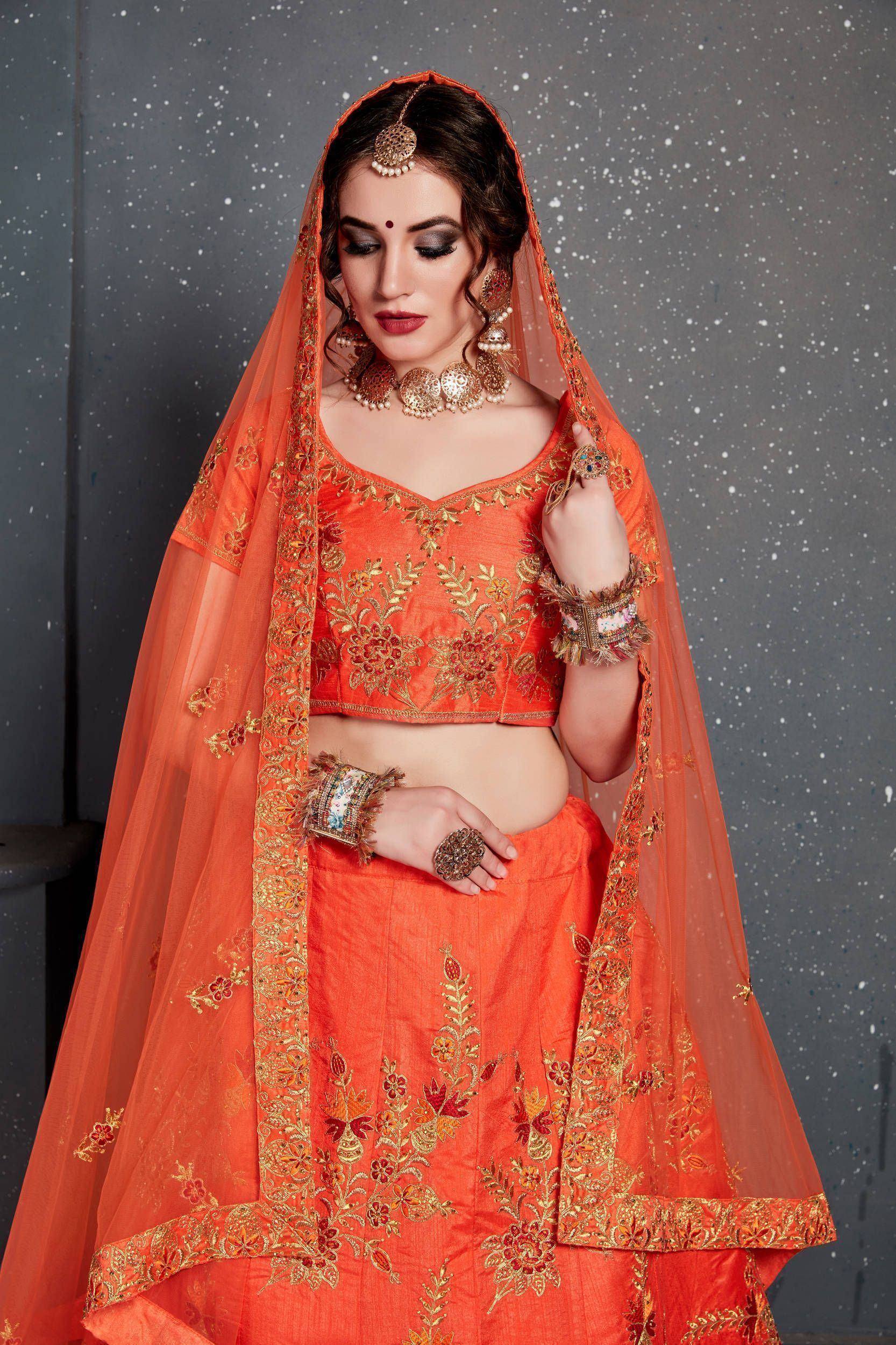 Orange embroidered lehenga choli with gold floral work and matching dupatta, traditional Indian ethnic wear