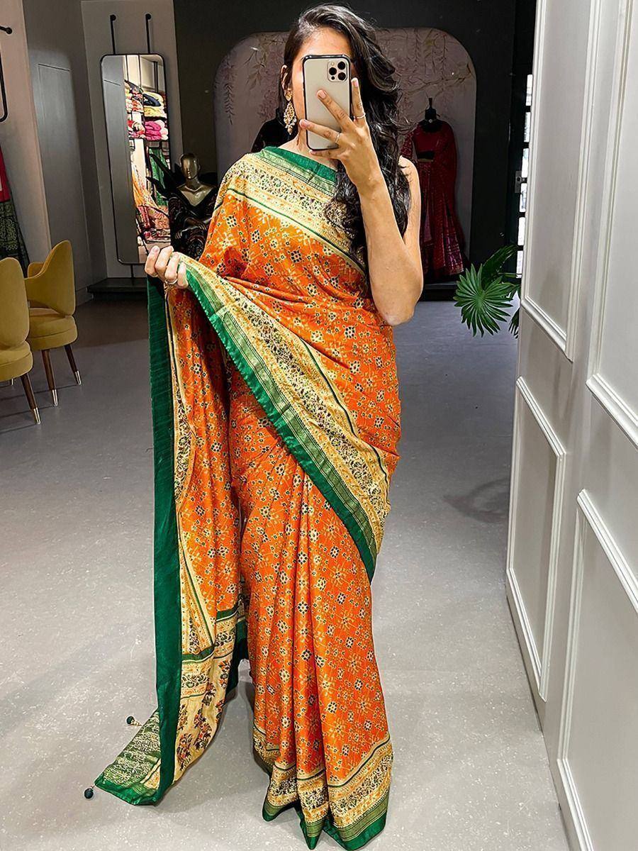 Orange floral print saree with green border, styled for ethnic wear