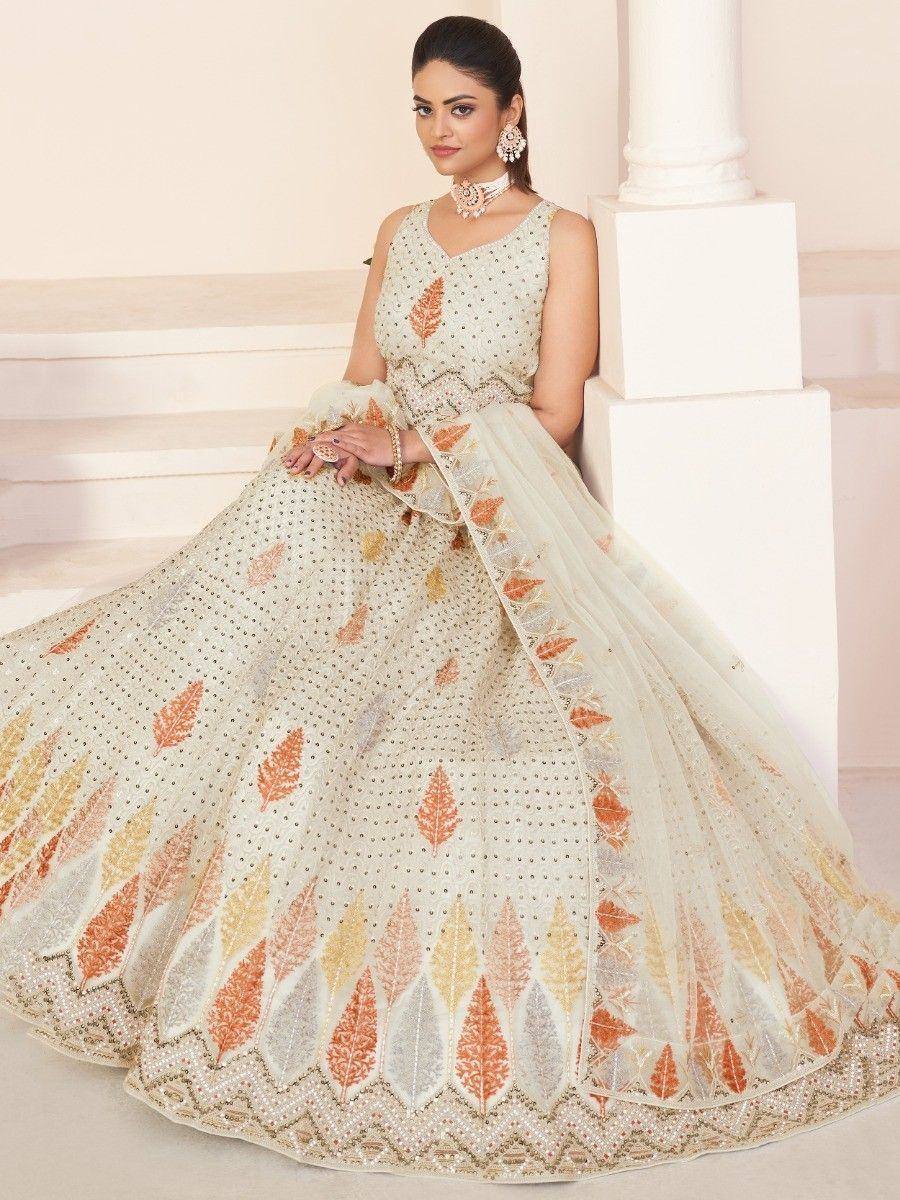 Elegant ivory lehenga choli with orange leaf embroidery and pearl detailing, perfect for Indian weddings.