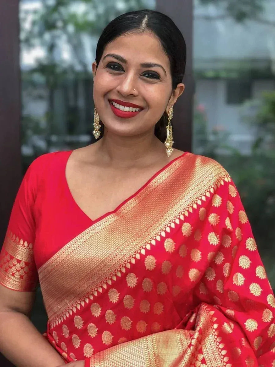 Woman in red and gold designer saree with floral motifs, perfect for Indian ethnic occasions