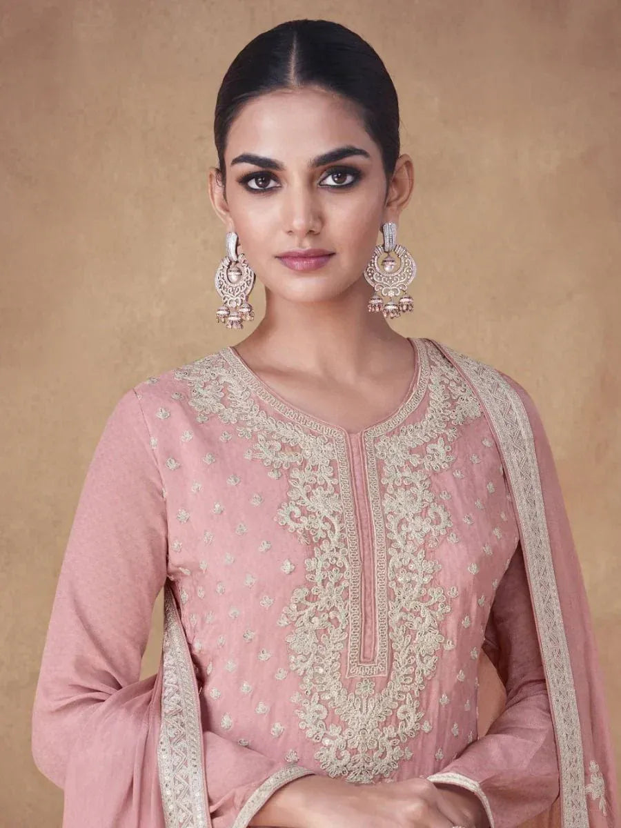 Pink embroidered ethnic salwar kameez with gold detailing and matching dupatta, styled with jhumka earrings