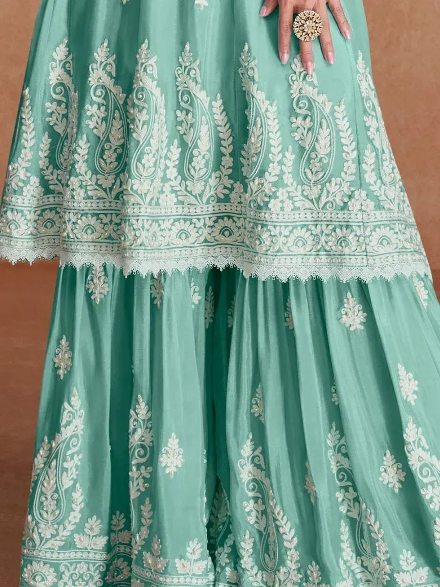 Mint green lehenga with white paisley embroidery and lace trim, perfect for Indian ethnic wear occasions.