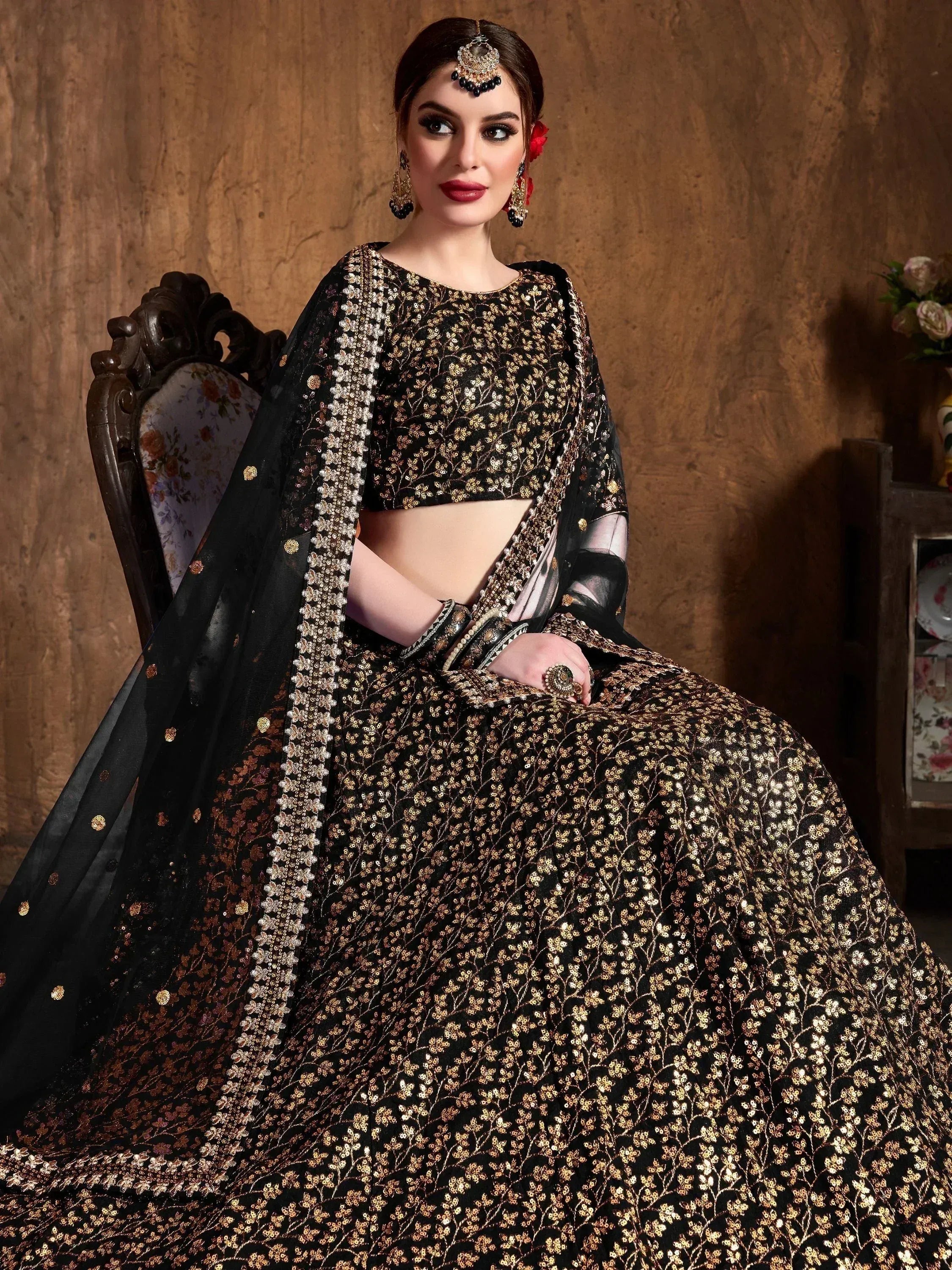 Black and gold embroidered lehenga choli with sheer dupatta, perfect for Indian weddings and festive occasions