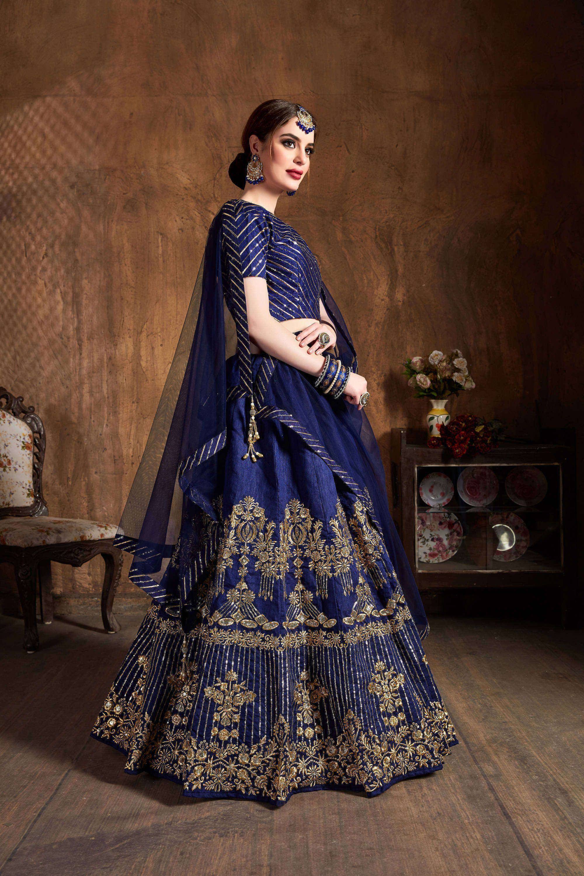 Royal blue lehenga choli with gold embroidery, perfect for Indian weddings and festive occasions.