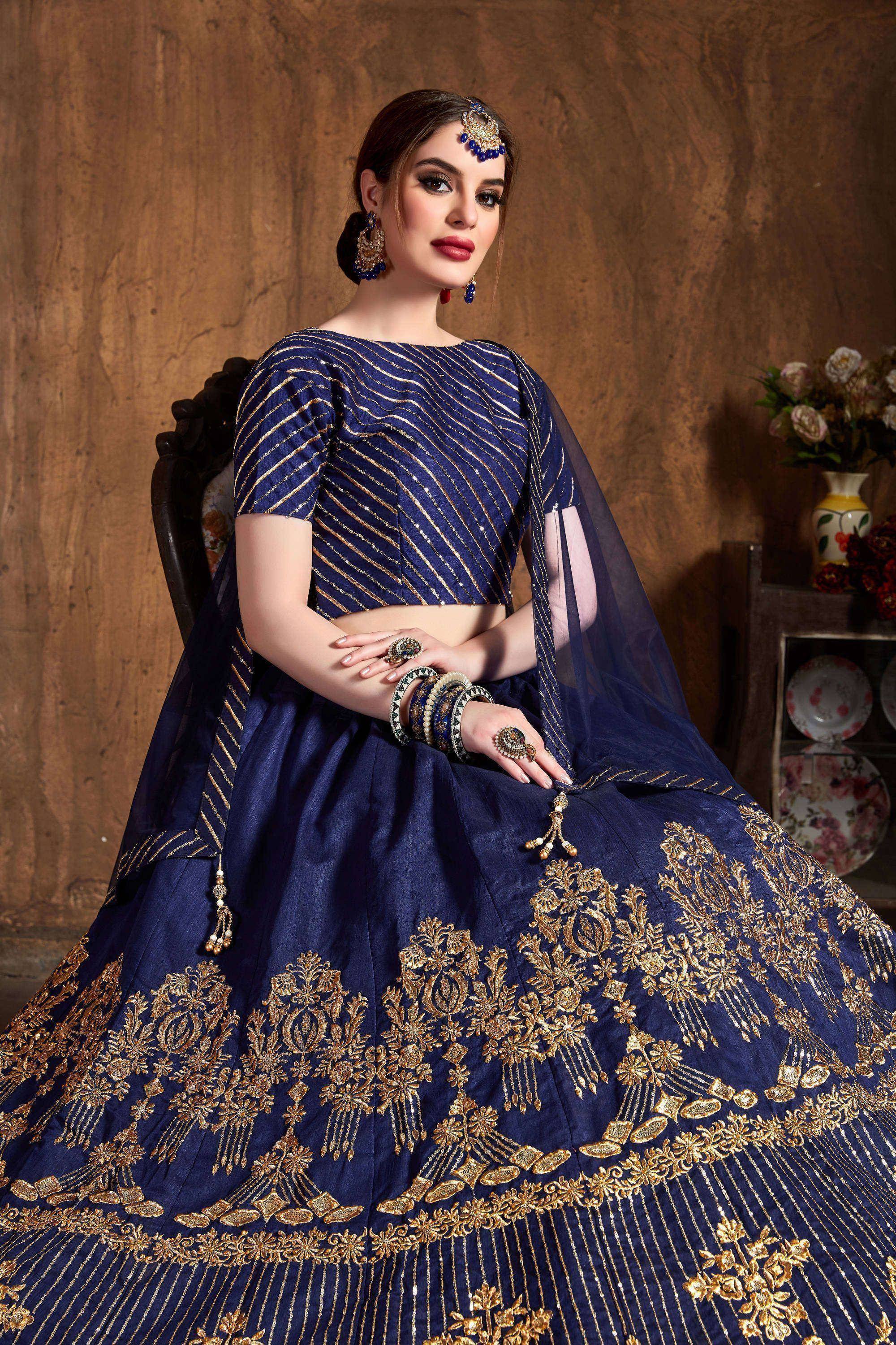 Navy blue designer lehenga choli with gold embroidery, perfect for Indian weddings and festive occasions.