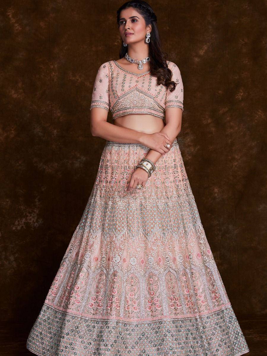 Pink embroidered lehenga choli with detailed floral motifs and silver embellishments, perfect for Indian weddings.
