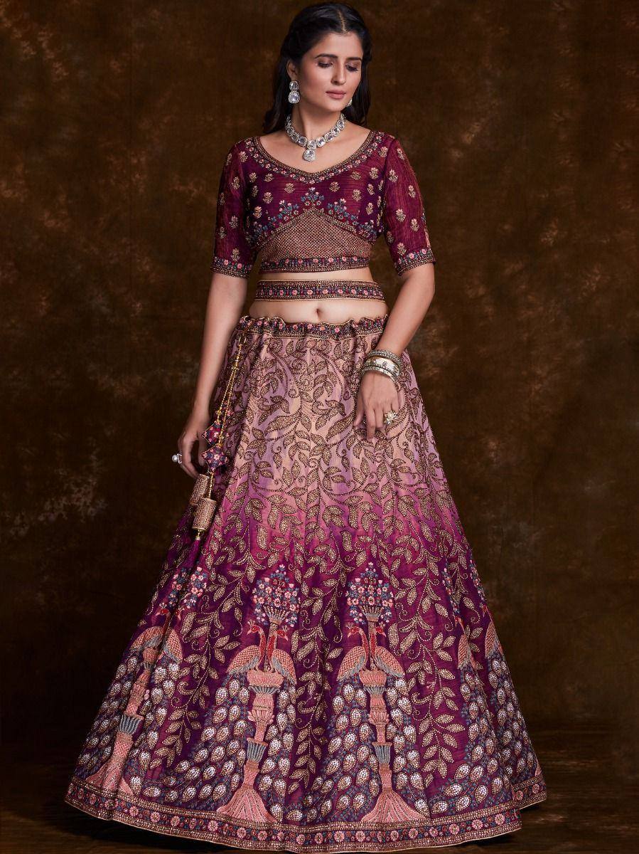 Elegant maroon and pink embroidered lehenga choli with peacock motifs, perfect for Indian weddings and festive occasions.