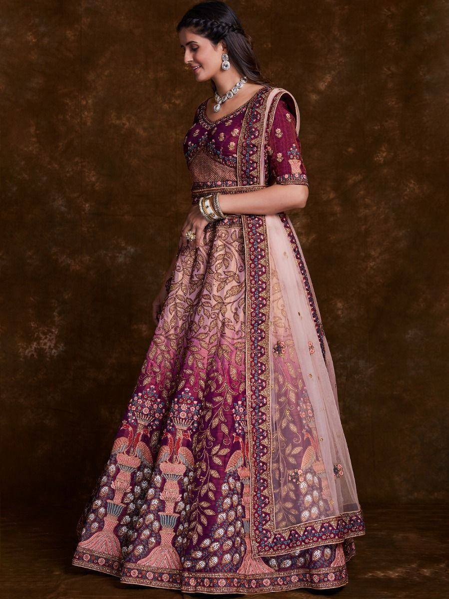 Elegant maroon and pink embroidered lehenga choli with peacock motifs, perfect for Indian weddings and festive occasions.
