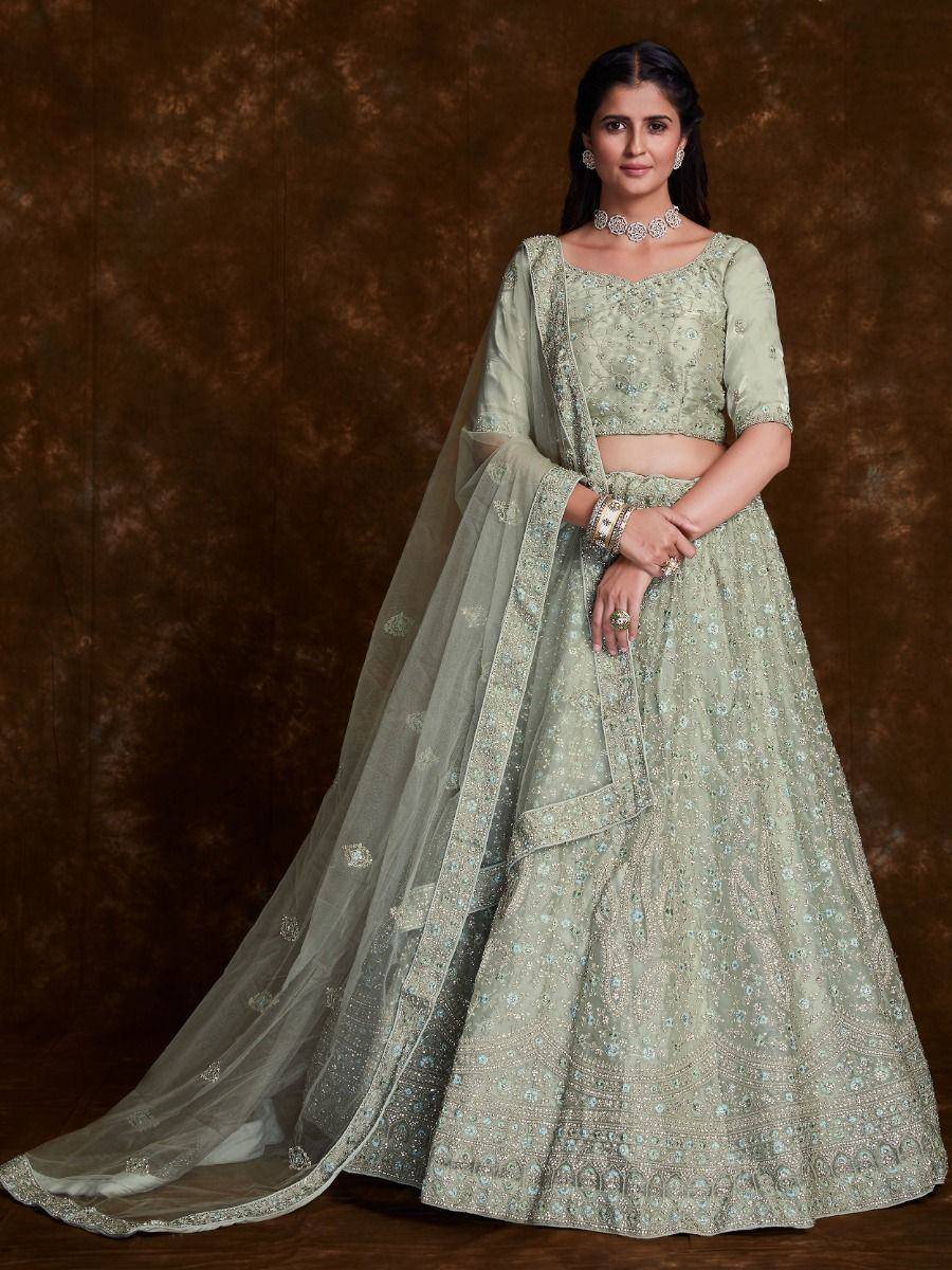 Elegant mint green embroidered lehenga choli with sheer dupatta, perfect for Indian weddings and festive occasions.
