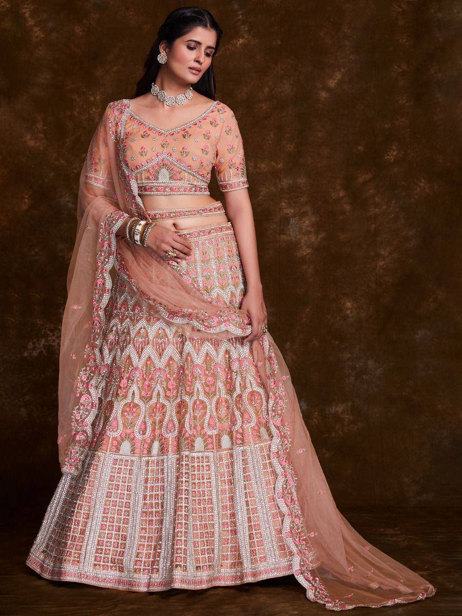 Pink and gold embroidered lehenga choli with floral motifs and sheer dupatta, perfect for Indian weddings or festive occasions.