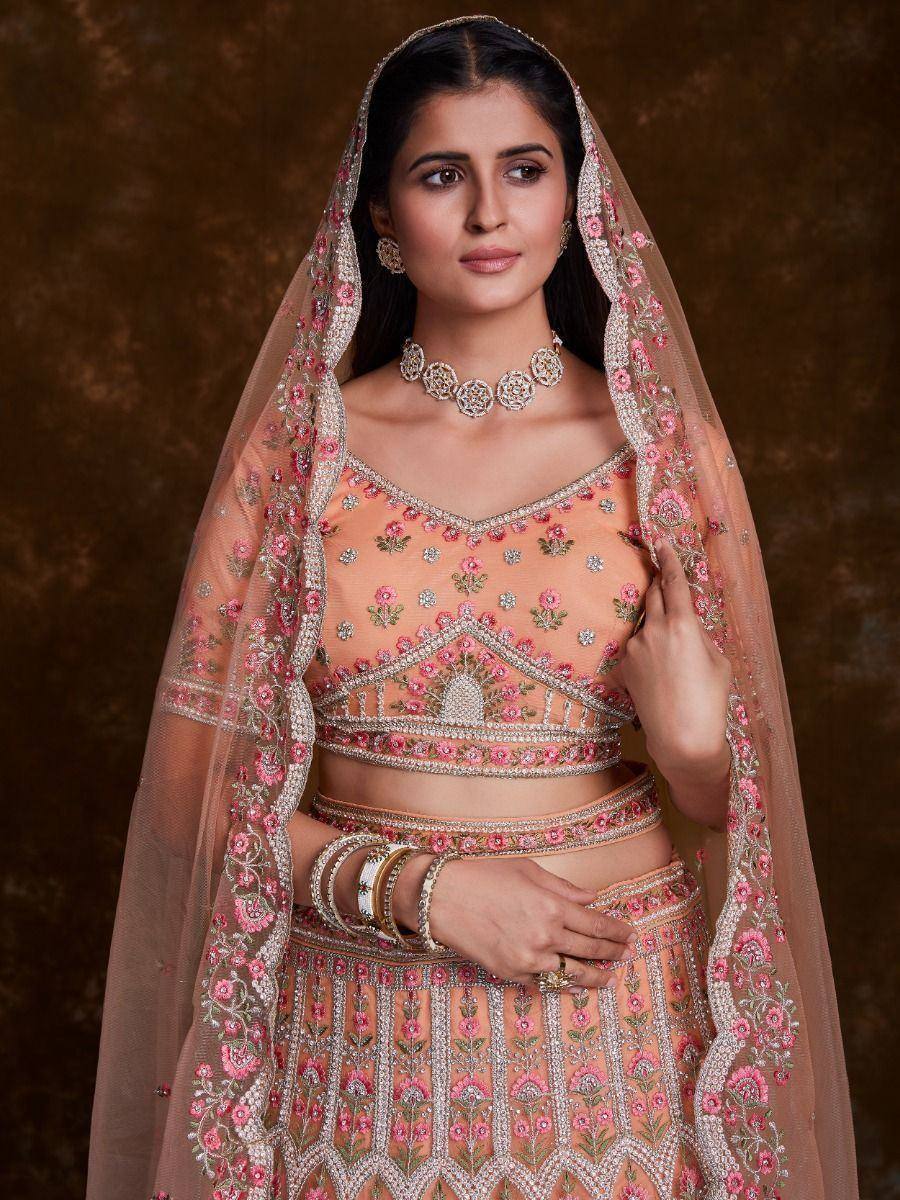 Peach floral embroidered lehenga choli with matching dupatta, perfect for Indian weddings and festive occasions.
