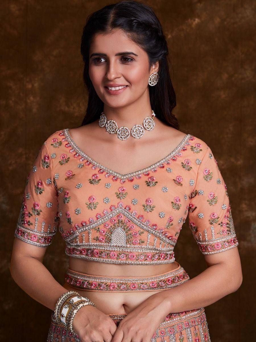 Peach floral embroidered lehenga choli with silver embellishments and matching jewelry