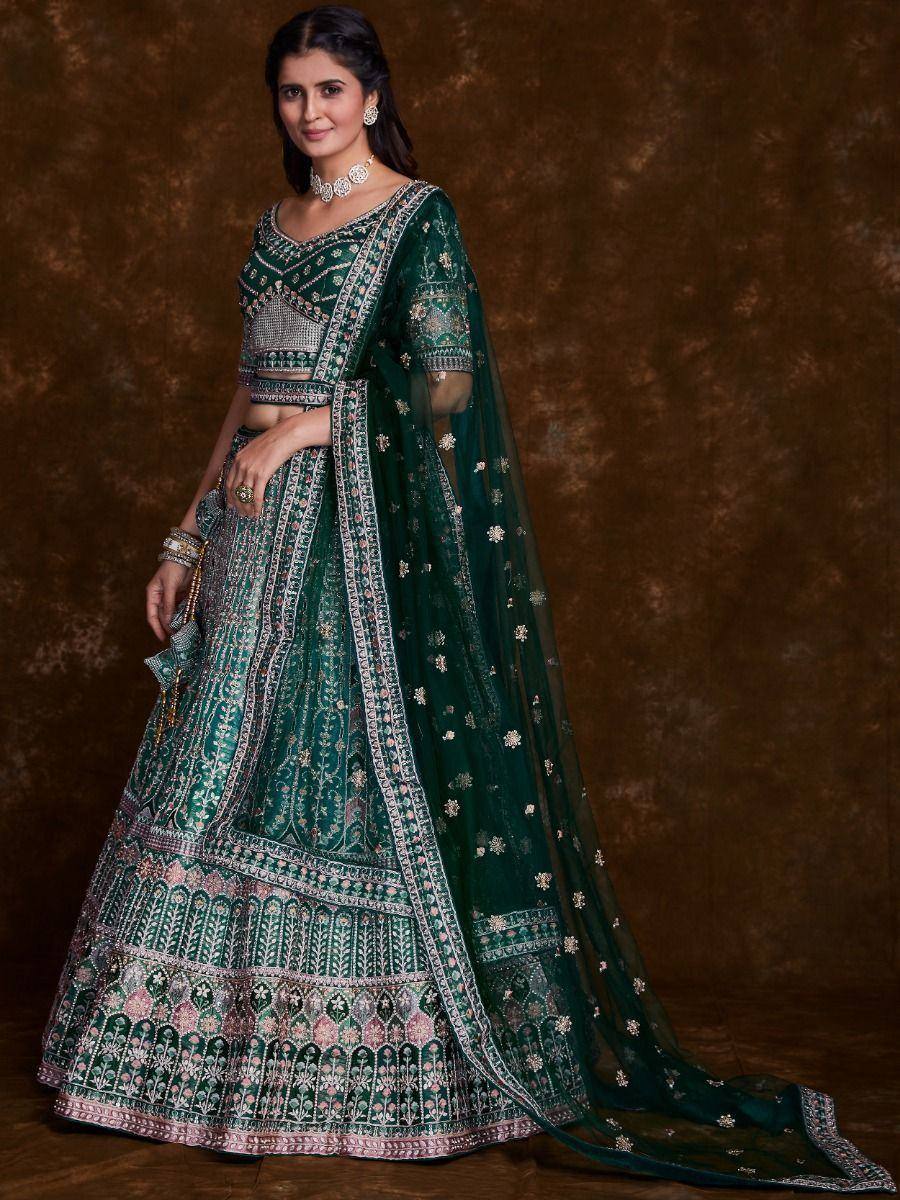 Emerald green designer lehenga choli with intricate embroidery and matching dupatta, perfect for Indian ethnic occasions.