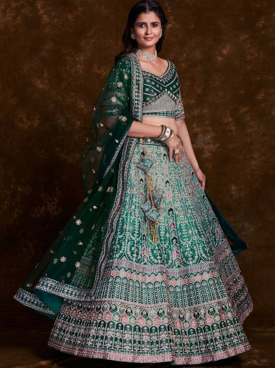 Emerald green designer lehenga choli with intricate embroidery and matching dupatta, perfect for weddings and festive occasions.