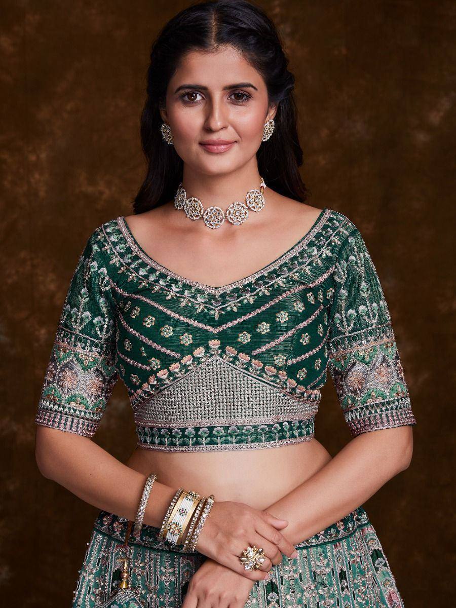 Green embroidered lehenga choli with floral motifs, perfect for Indian ethnic wear and festive occasions.