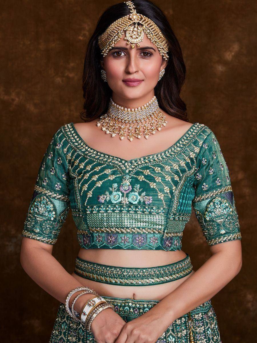 Emerald green designer lehenga choli with gold embroidery, perfect for Indian weddings and festive occasions.