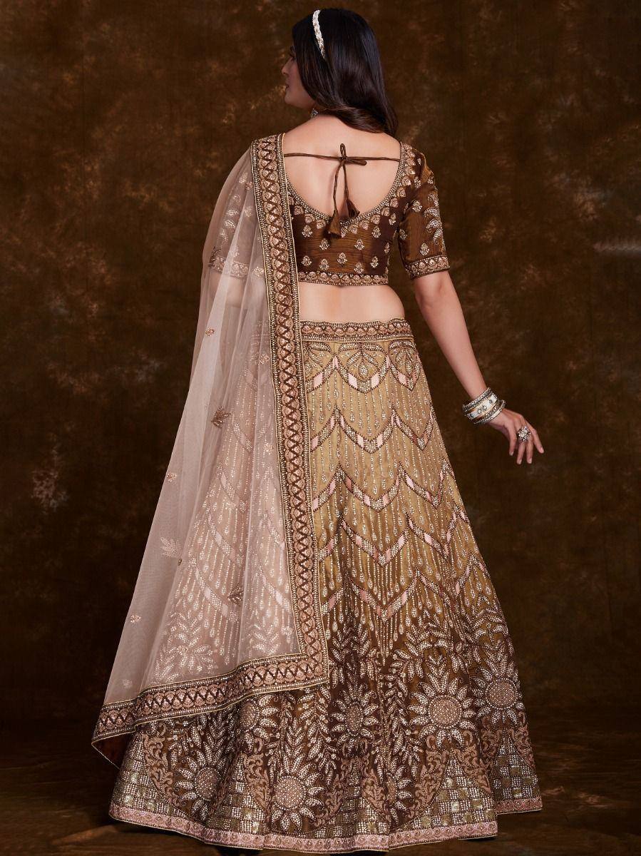 Designer lehenga choli with intricate gold embroidery and sheer dupatta, perfect for Indian weddings and festive occasions.