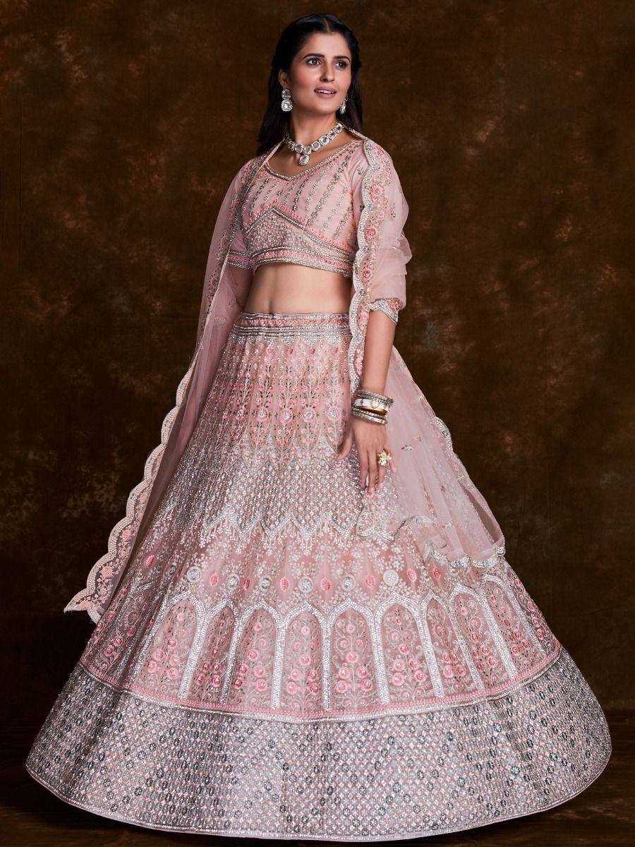 Pink embroidered lehenga choli with heavy embellishments, perfect for Indian weddings and festive occasions.