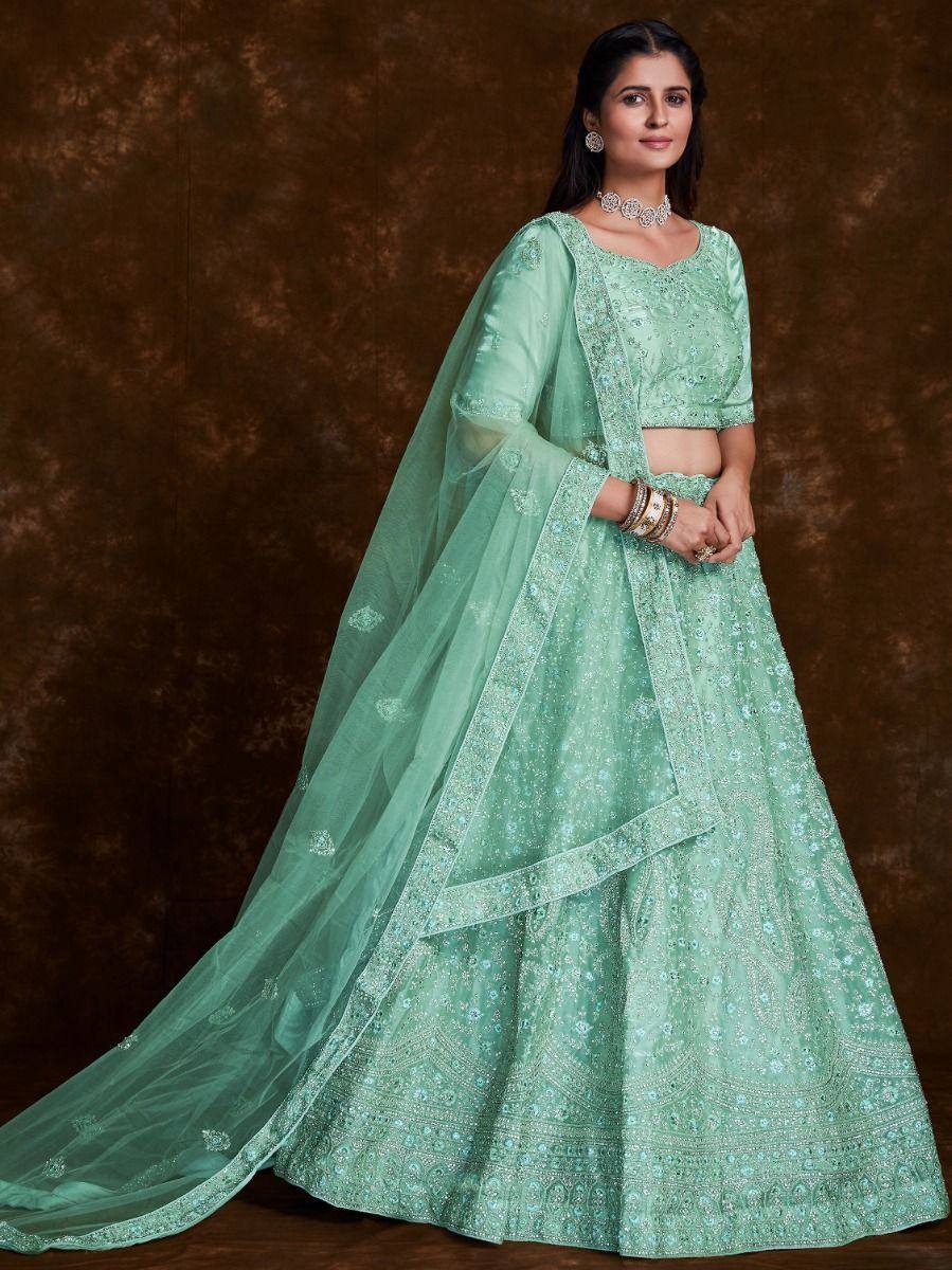 Mint green embroidered lehenga choli with sheer dupatta, perfect for Indian weddings and festive occasions.
