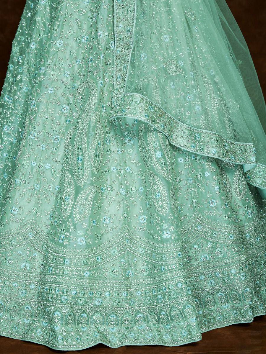 Mint green designer lehenga with intricate silver and blue floral embroidery, perfect for Indian ethnic wear.
