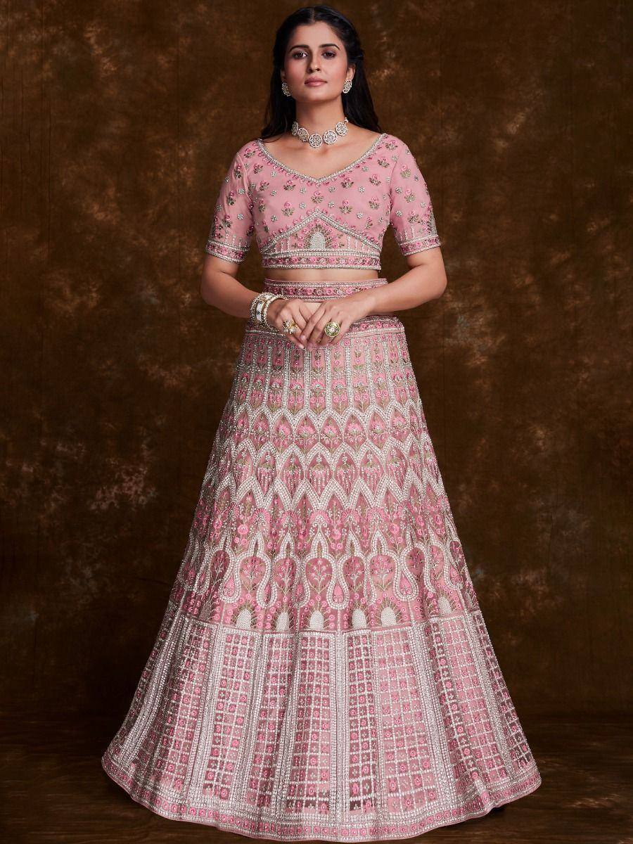 Pink embroidered lehenga choli with intricate floral and geometric patterns, perfect for Indian ethnic occasions.