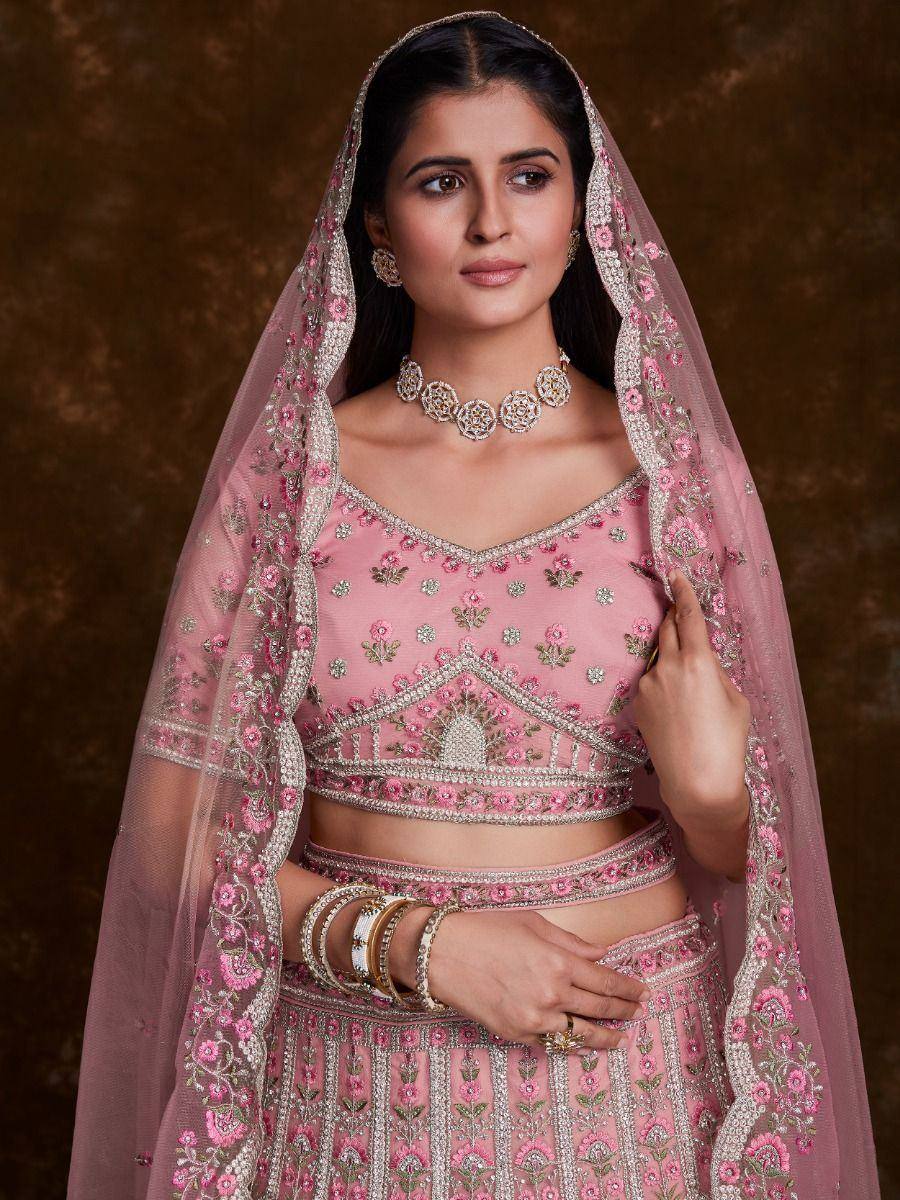 Pink embroidered lehenga choli with floral dupatta, perfect for Indian weddings and festive occasions.