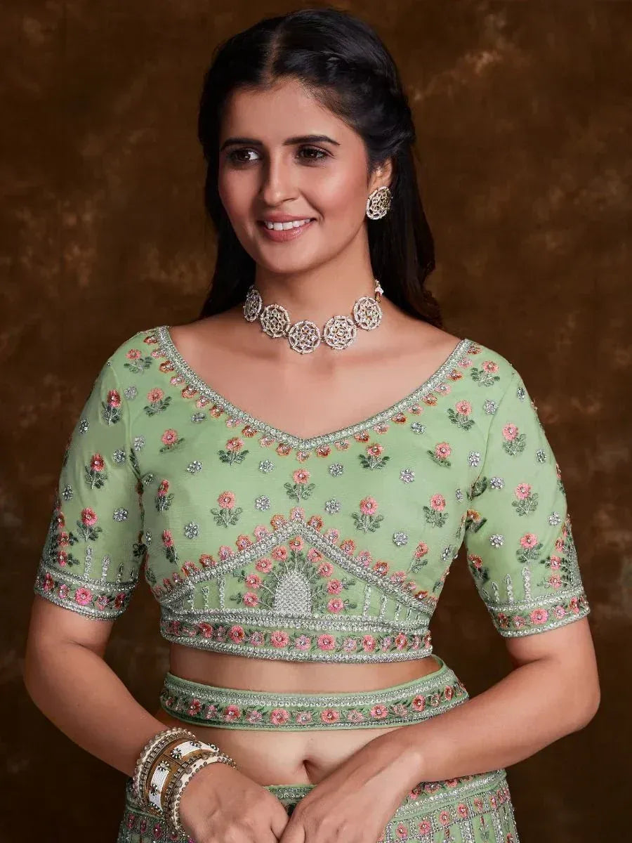 Mint green embroidered lehenga choli with floral motifs and silver detailing, perfect for Indian ethnic wear