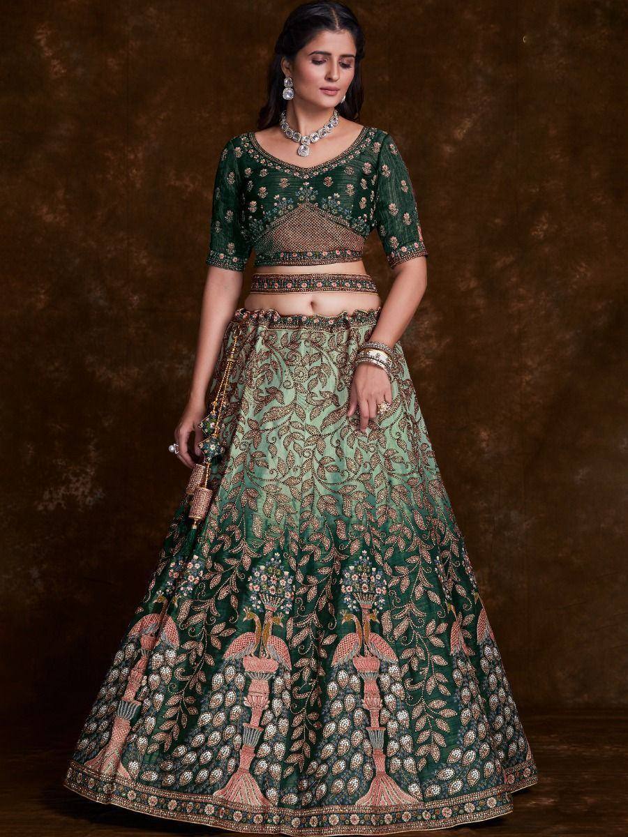 Emerald green designer lehenga choli with intricate floral and peacock embroidery, perfect for weddings and festive occasions.