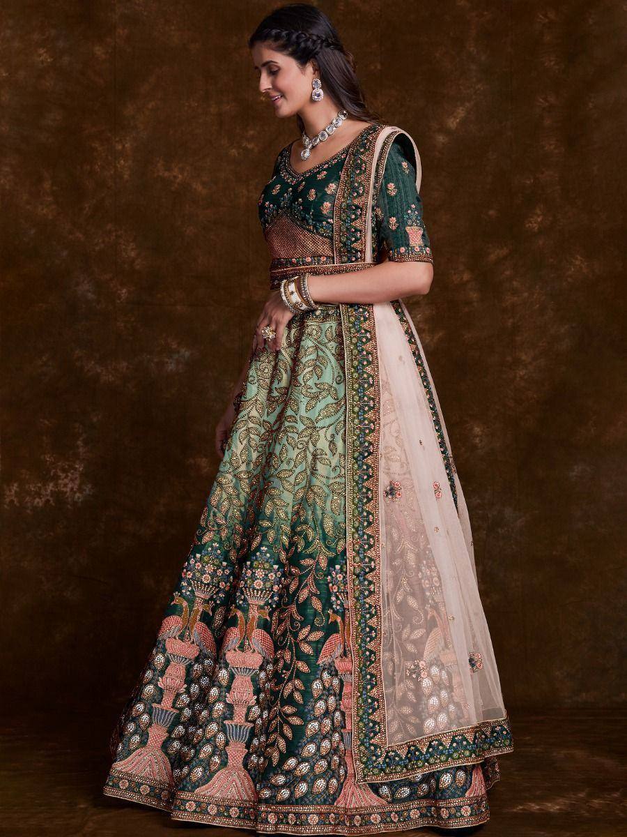Elegant green and pink embroidered lehenga choli with floral motifs and sheer dupatta, perfect for Indian weddings.