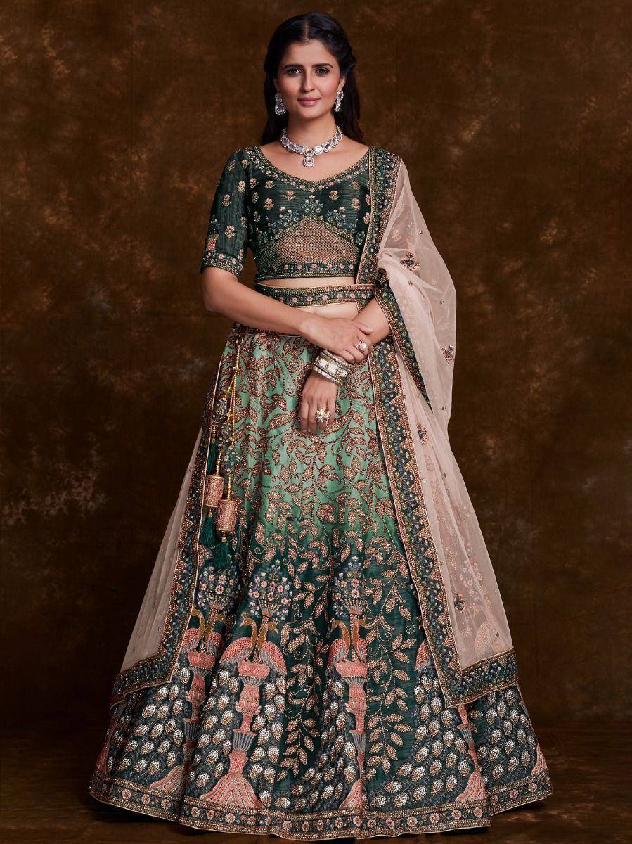 Emerald green designer lehenga choli with intricate floral embroidery and sheer dupatta, perfect for weddings