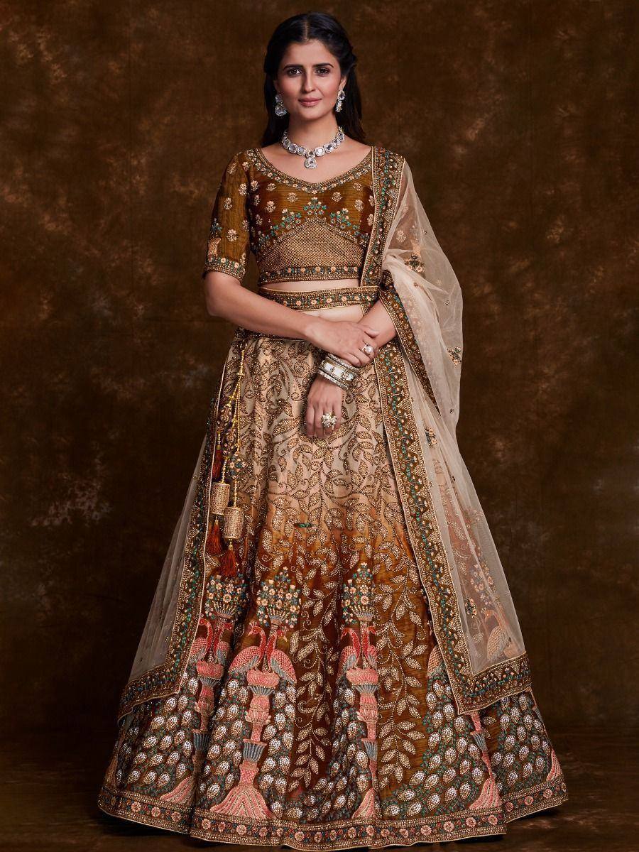 Designer lehenga choli with intricate embroidery and peacock motifs, perfect for Indian weddings and festive occasions.