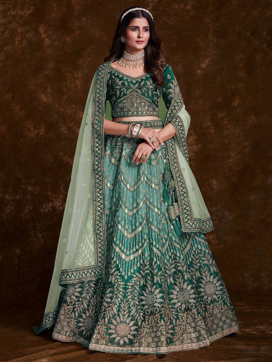 Emerald green designer lehenga choli with gold embroidery and matching dupatta, perfect for weddings and festive occasions.