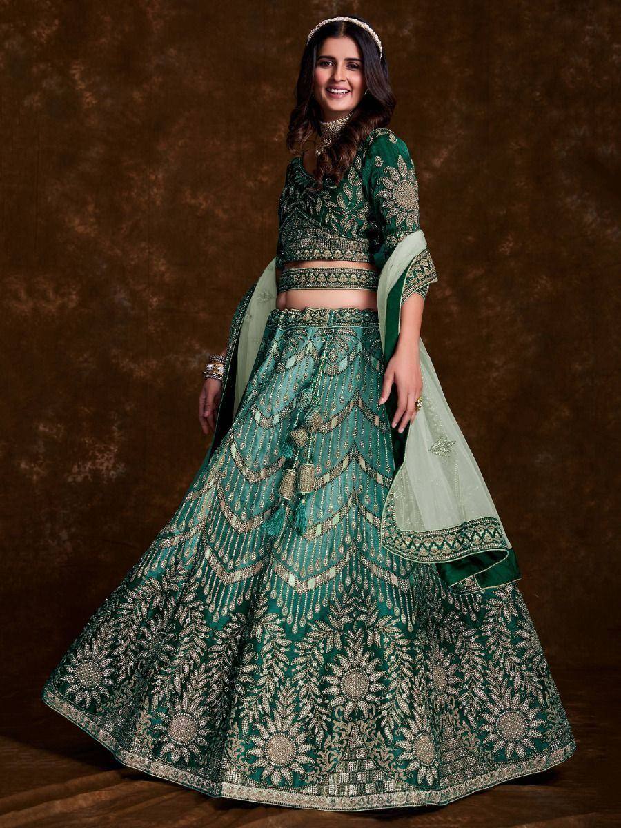 Emerald green designer lehenga choli with gold embroidery and floral motifs, perfect for Indian weddings and festive occasions.