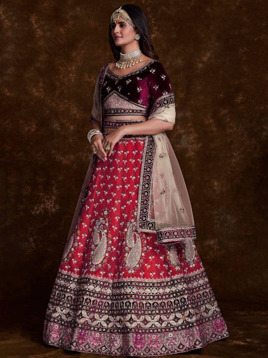 Elegant maroon and red embroidered lehenga choli with heavy embellishments and dupatta, perfect for Indian weddings and festive occasions.