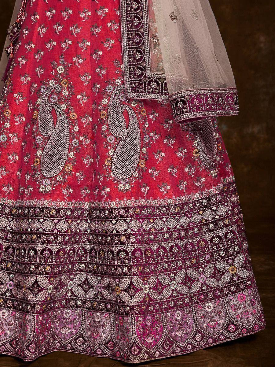 Red designer lehenga with intricate paisley and floral embroidery, perfect for Indian weddings and festive occasions.