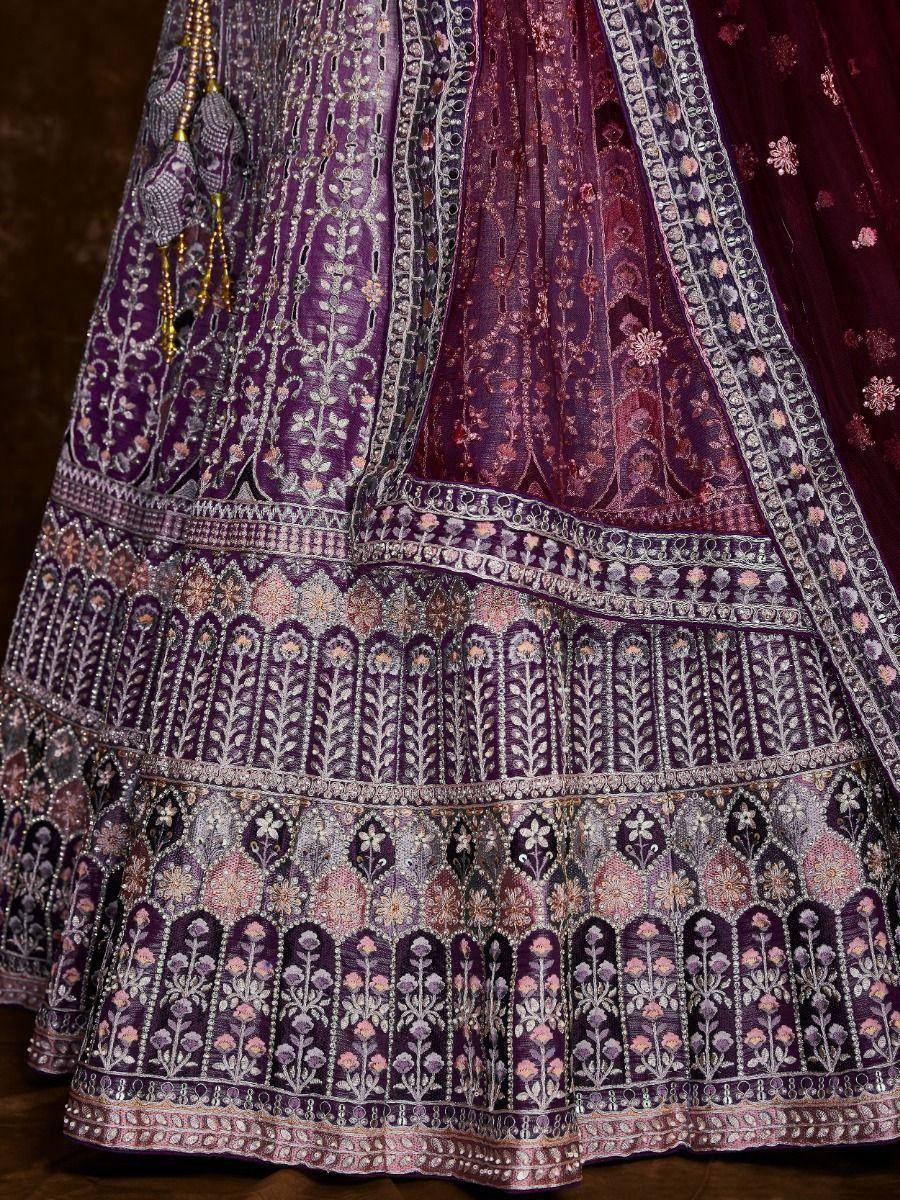 Purple designer lehenga with intricate floral embroidery and embellished borders, perfect for weddings.
