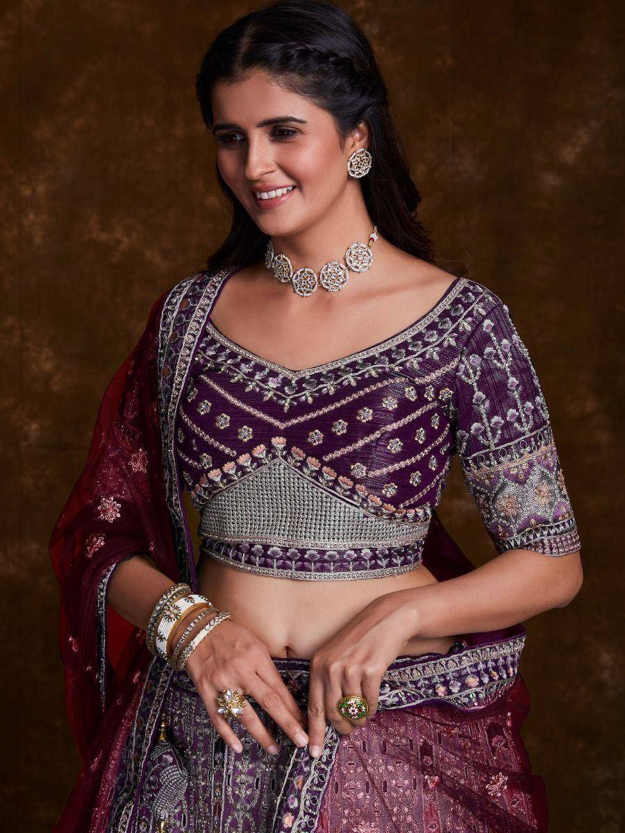 Purple embroidered lehenga choli with silver detailing, paired with matching dupatta and traditional jewelry