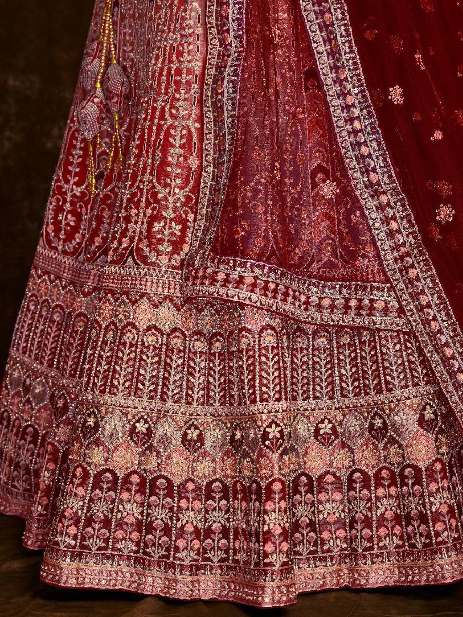 Rich maroon lehenga with intricate gold and pink embroidery, perfect for Indian ethnic wear