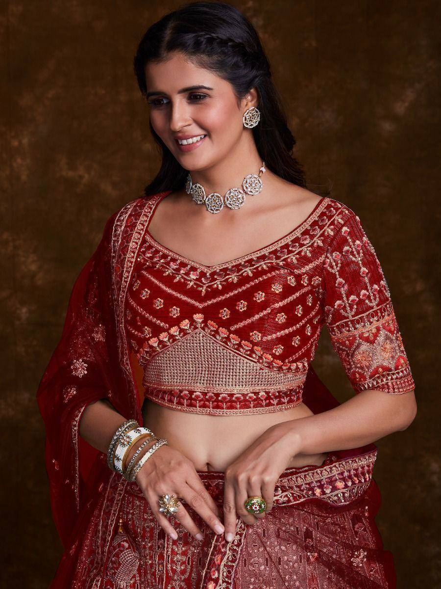Red embroidered lehenga choli with gold detailing, perfect for Indian weddings and festive occasions