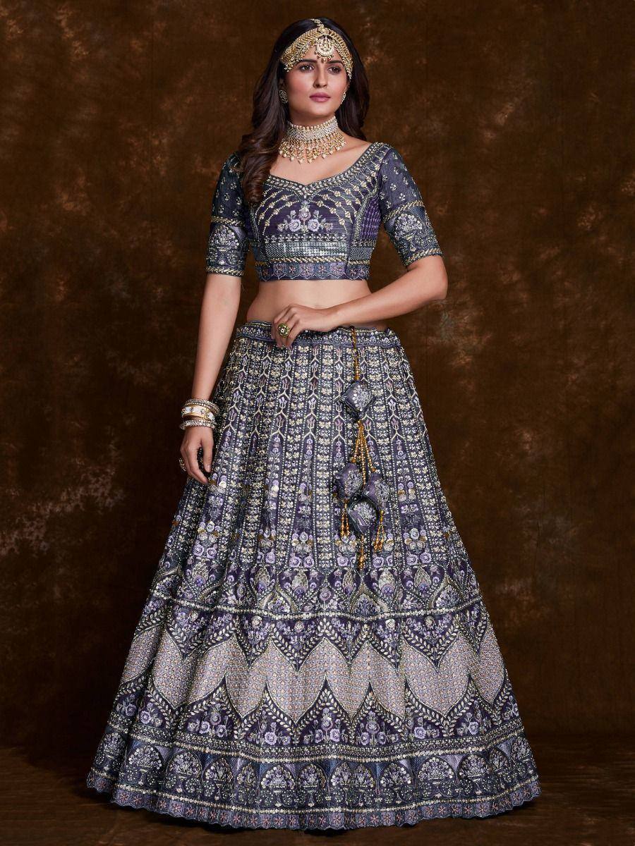 Elegant purple lehenga choli with intricate embroidery and gold jewelry, perfect for Indian weddings and festivals.