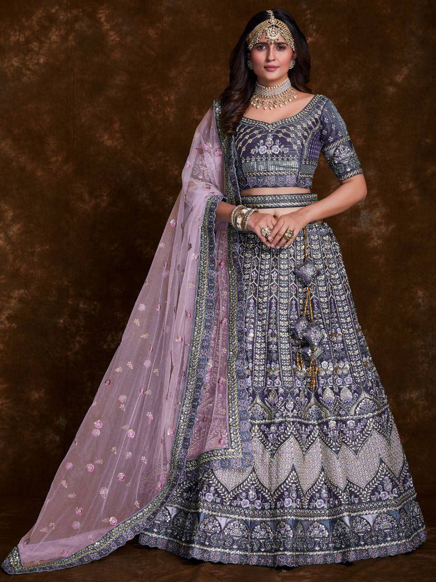 Elegant purple embroidered lehenga choli with floral dupatta, perfect for Indian weddings and festive occasions.