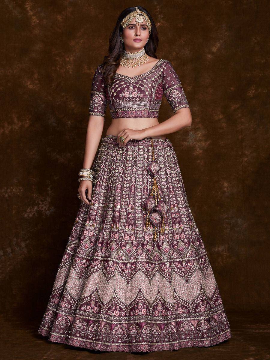 Elegant maroon lehenga choli with intricate floral embroidery and gold detailing, perfect for Indian weddings.