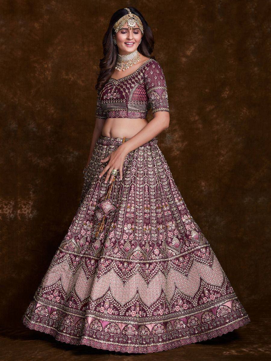 Elegant maroon lehenga choli with intricate gold embroidery, perfect for Indian weddings and festive occasions.