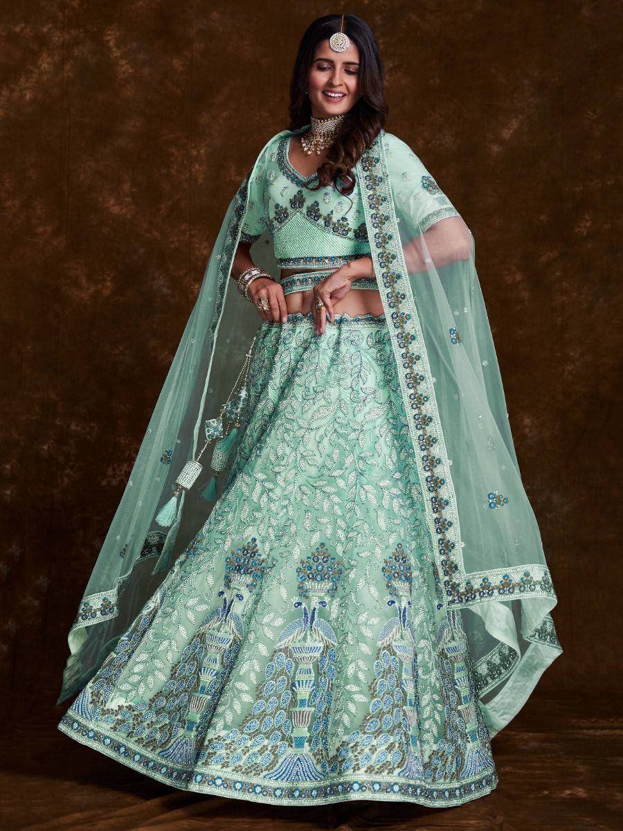 Mint green designer lehenga choli with peacock embroidery and sheer dupatta, perfect for Indian weddings and festive occasions.