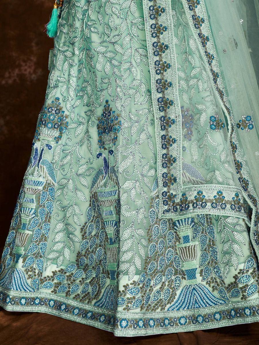 Mint green designer lehenga with peacock embroidery and blue beadwork, perfect for Indian ethnic wear